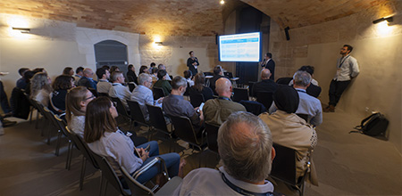 Audience seated in chairs at a conference