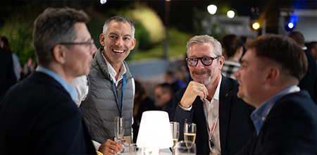 Partners discussing during an evening event