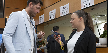 Man handing his admission ticket to a hostess