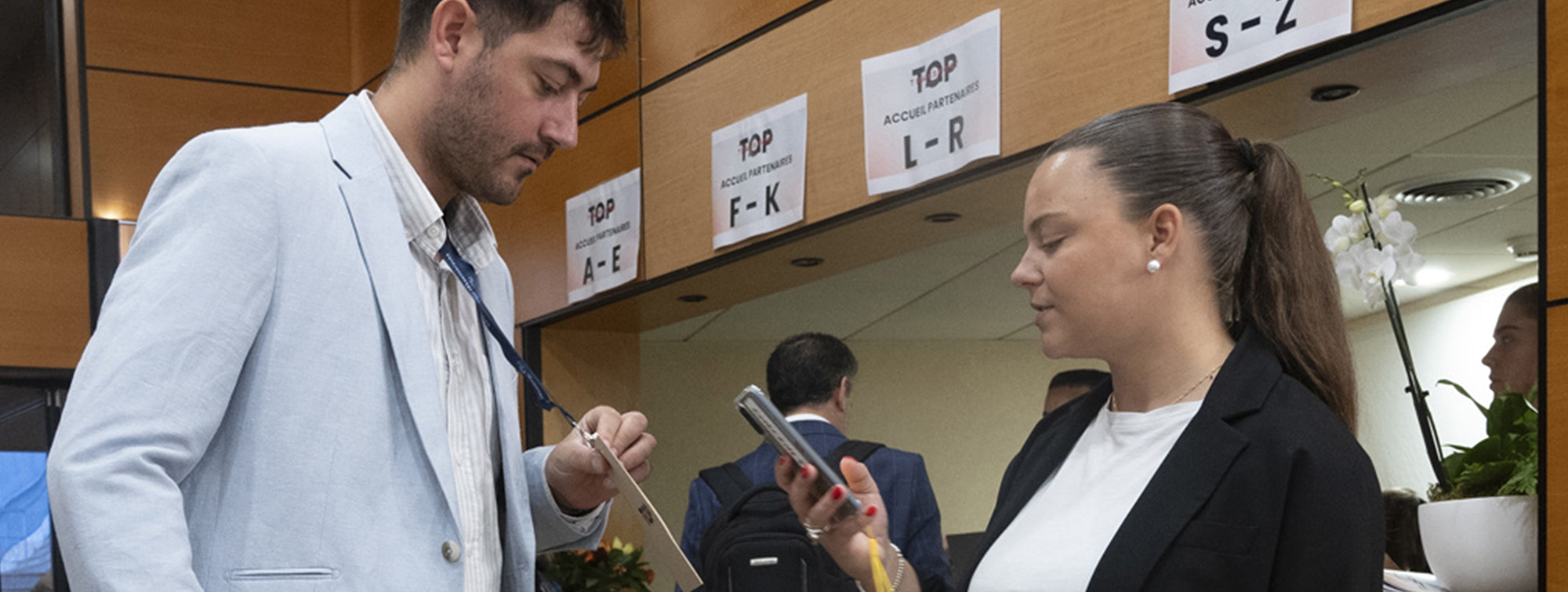 Man handing his admission ticket to a hostess