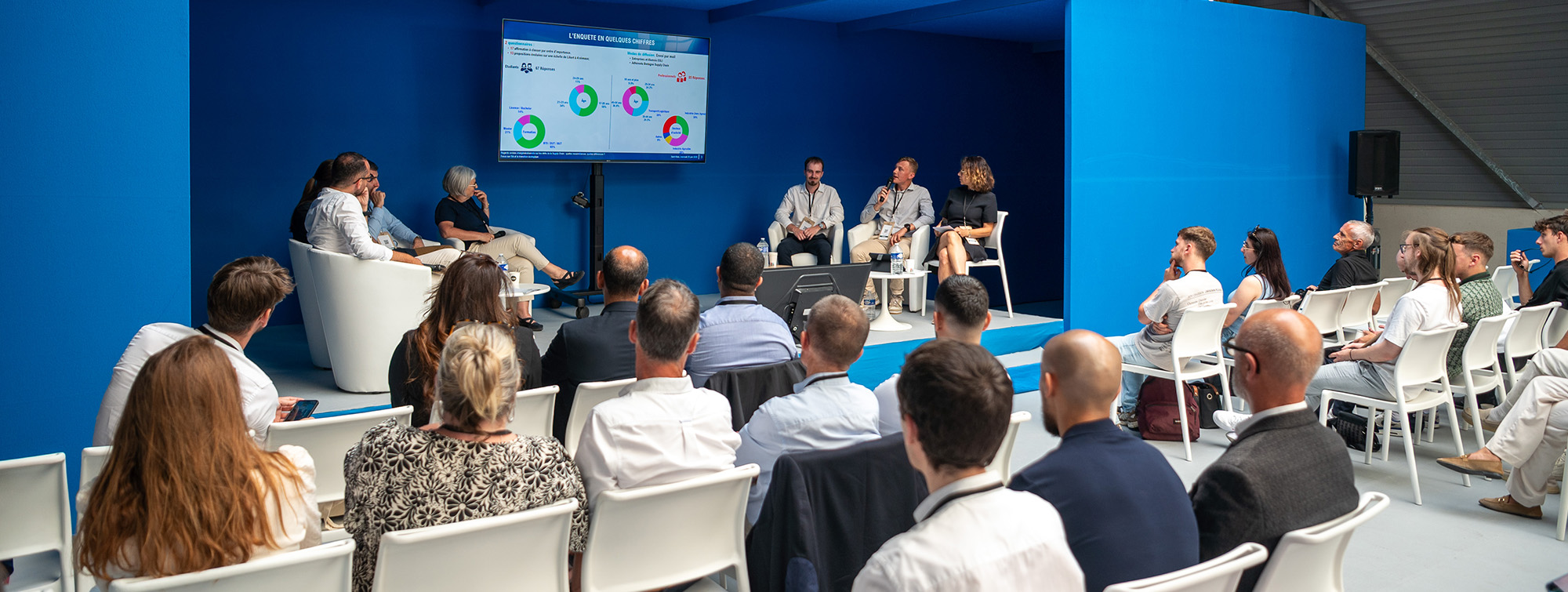 Public attending a conference in a blue room