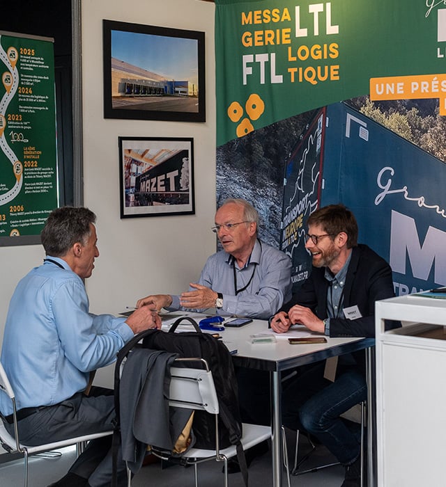 Exhibitor in a booth with green posters