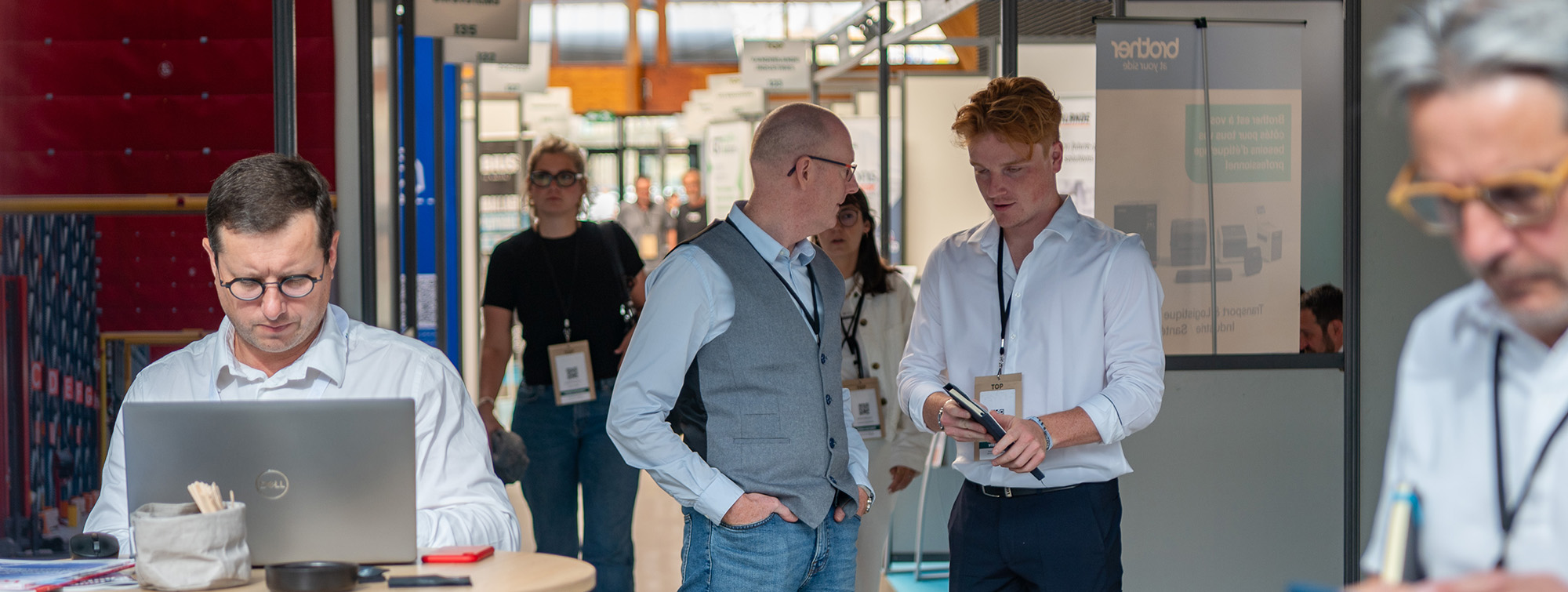 Visitors walking between booths at the trade show